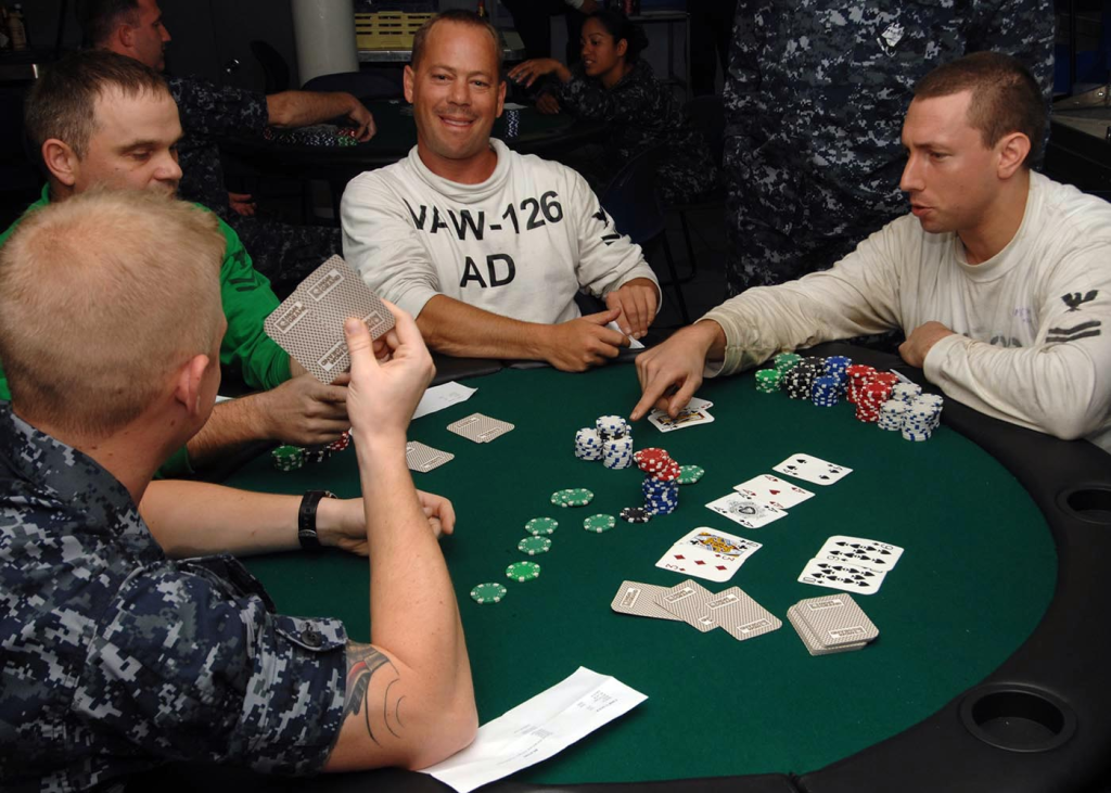  A group of people playing poker at a green felt table, highlighting a beginner’s popular choice of casino games with social interaction.