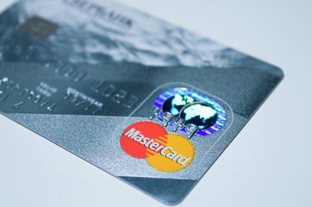 A close-up of a Mastercard credit card with embossed details.